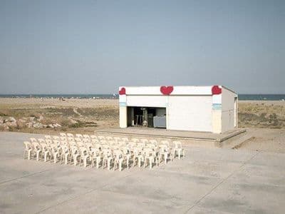 a group of white chairs sitting in front of a building