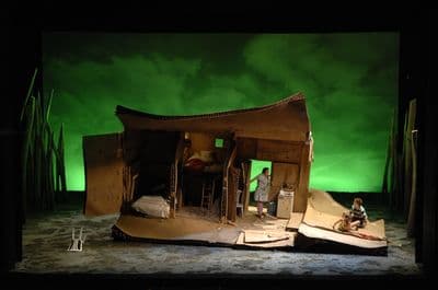 a stage set with a man and a woman in a boat