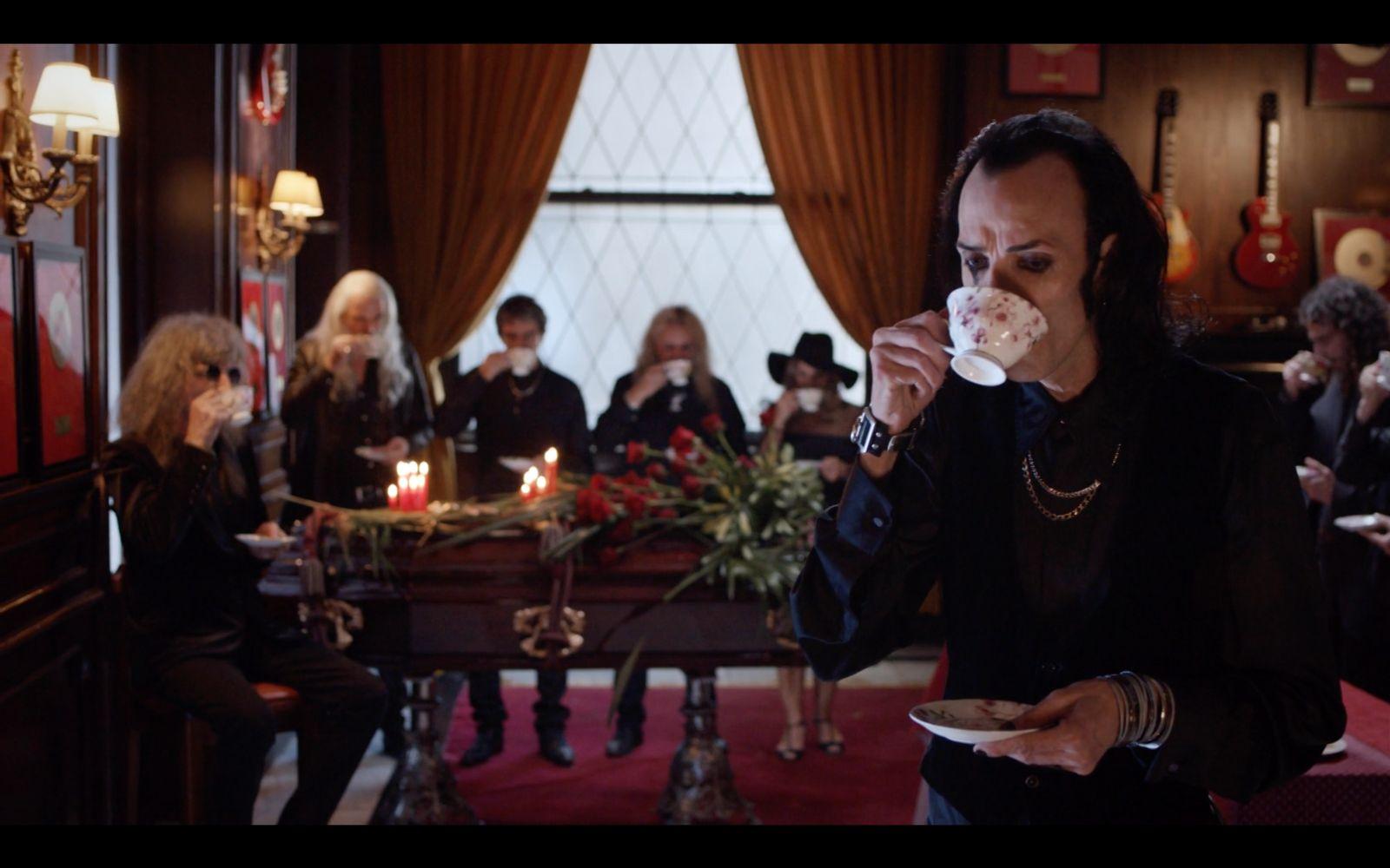 a man eating a donut in front of a group of people