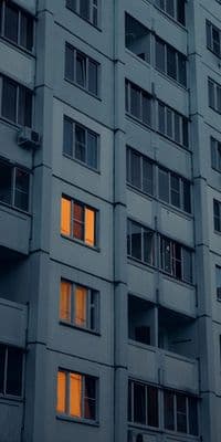a tall building with many windows at night