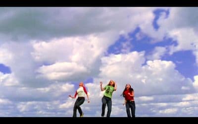 a group of people flying a kite in the sky