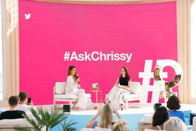 a group of women sitting on top of a stage
