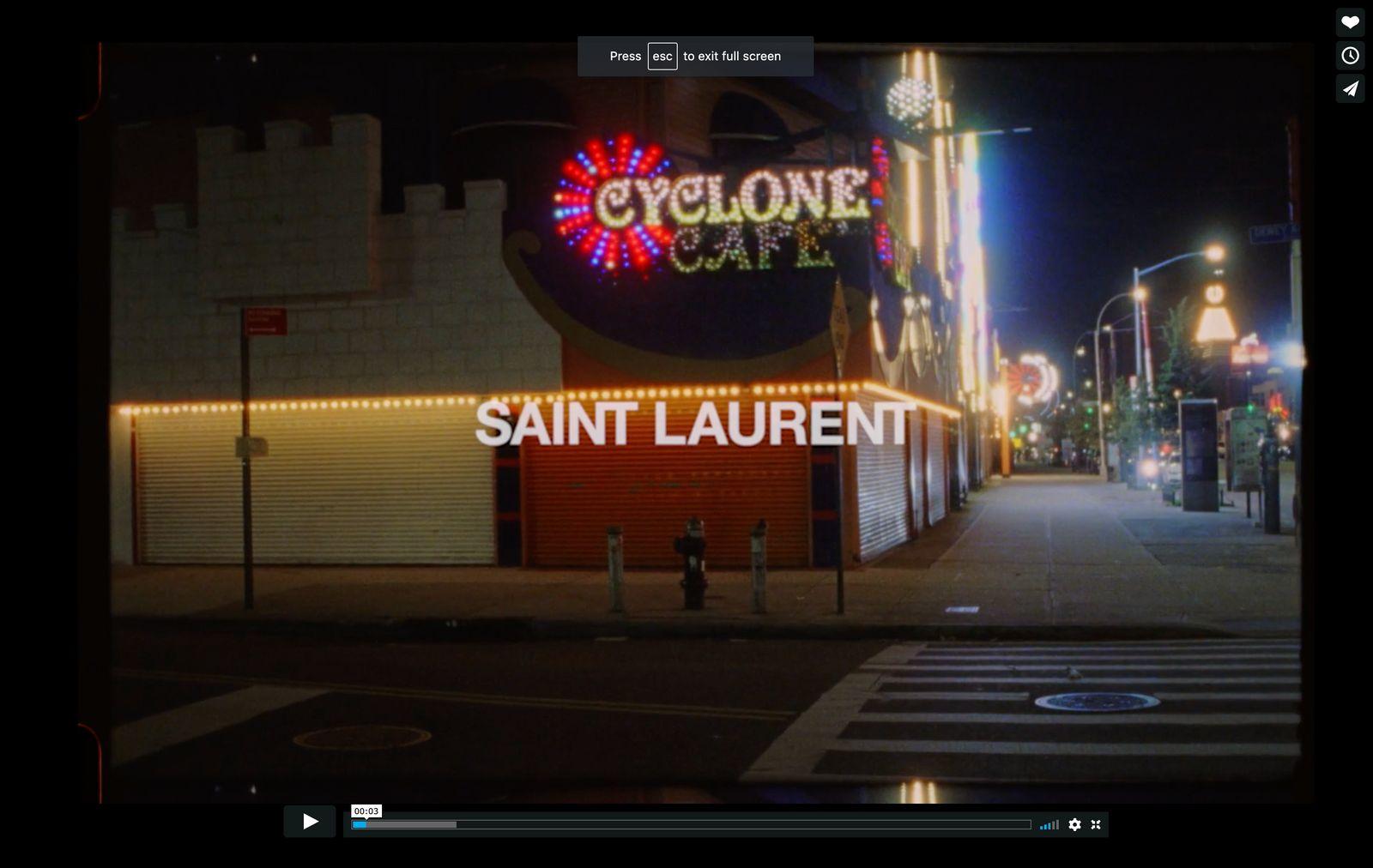 a picture of a street at night with a sign that says saint laurent