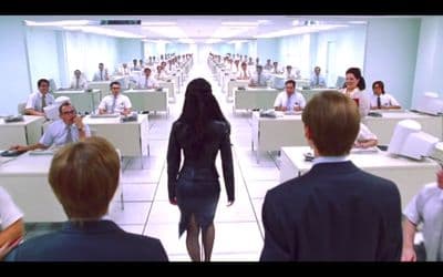 a woman walking through a room filled with people