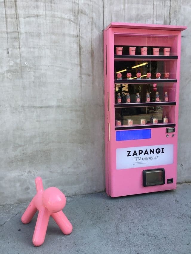 a pink toy sitting next to a pink machine