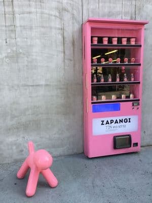 a pink toy sitting next to a pink machine