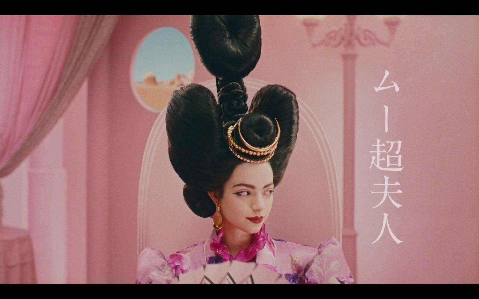 a woman with a large ponytail in a room