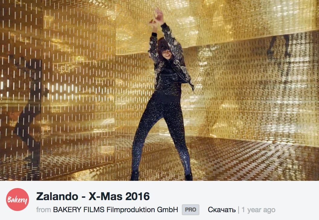 a man standing in front of a golden wall