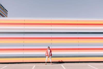 a man standing in front of a colorful wall