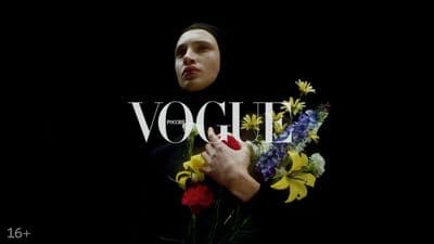 a woman holding a bouquet of flowers in front of a black background