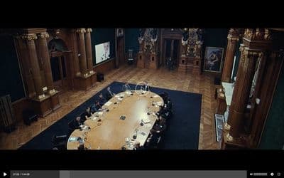 a conference room with a large wooden table