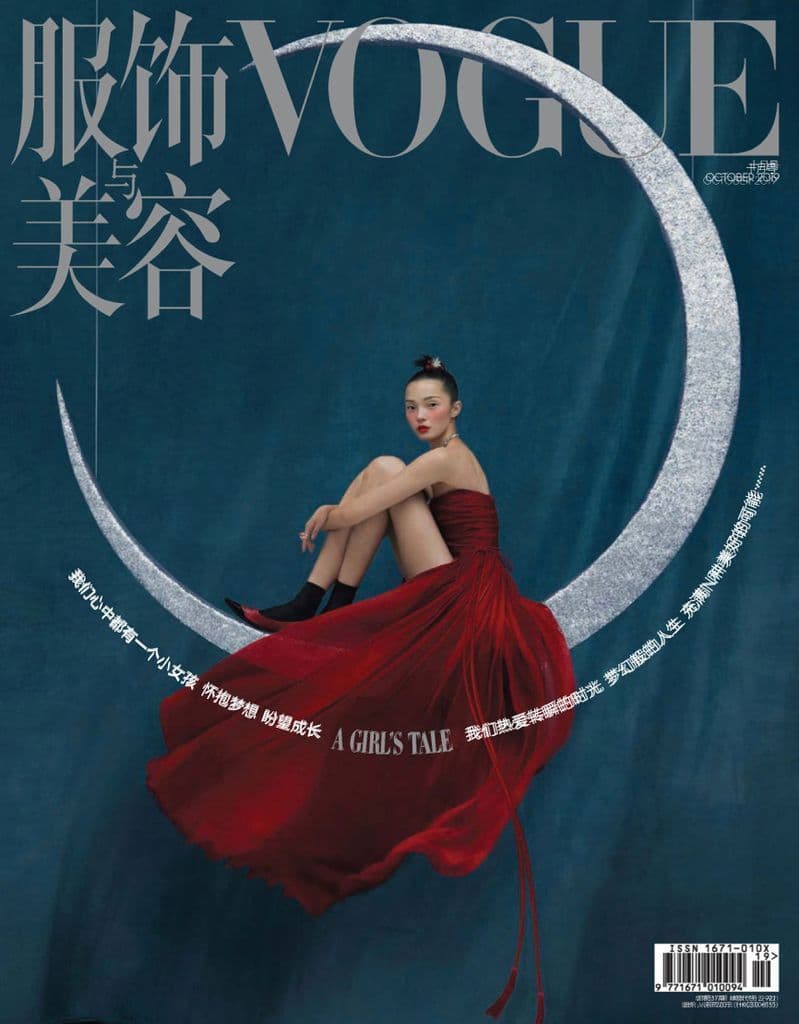 a woman in a red dress sitting on the moon