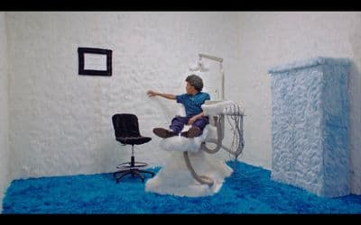 a man sitting on a chair in a room