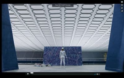 a person standing in front of a blue wall