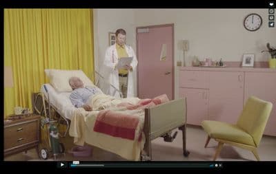 a man laying in a hospital bed next to a woman