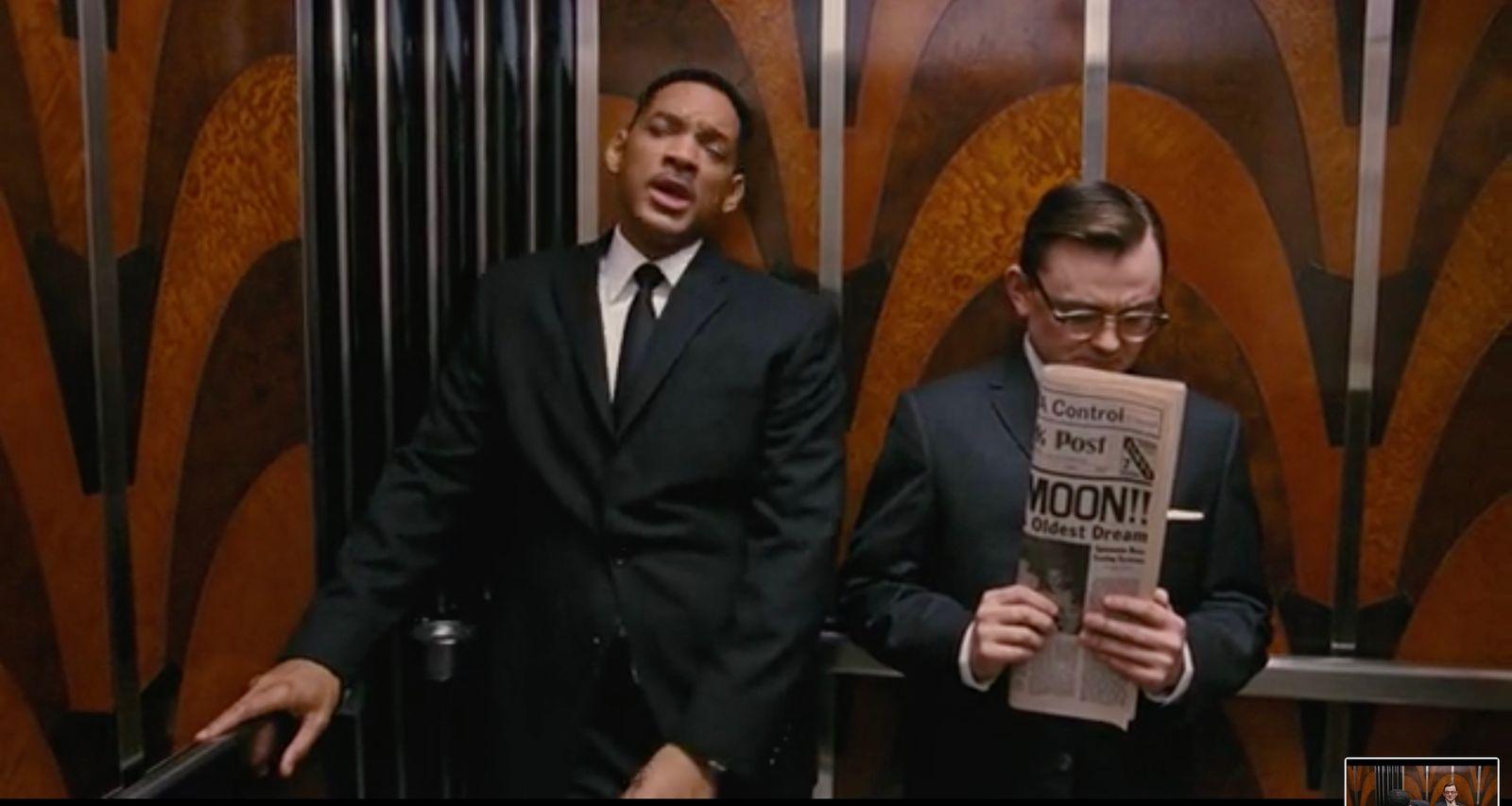 two men in suits standing next to each other