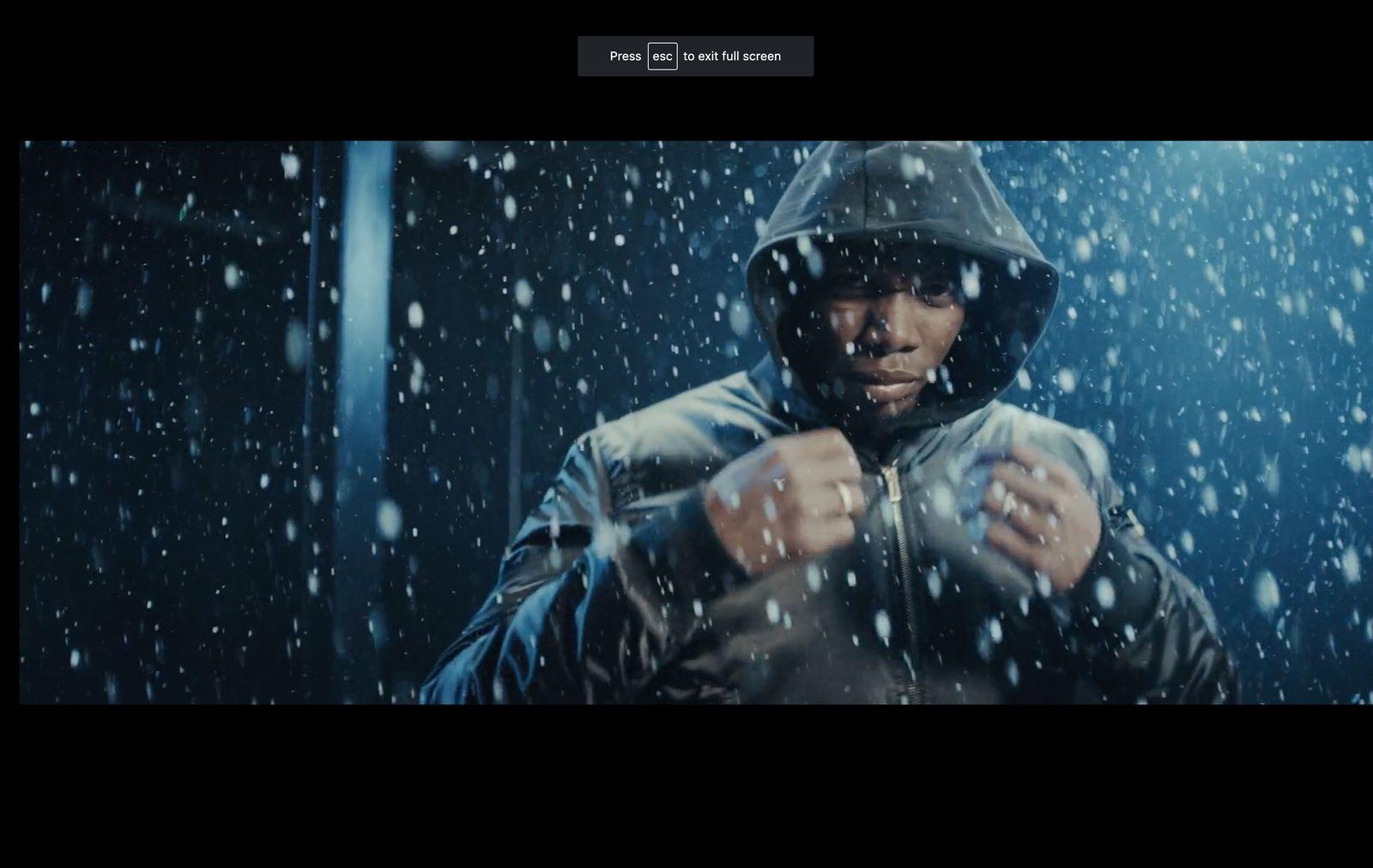 a man standing in the rain wearing a jacket