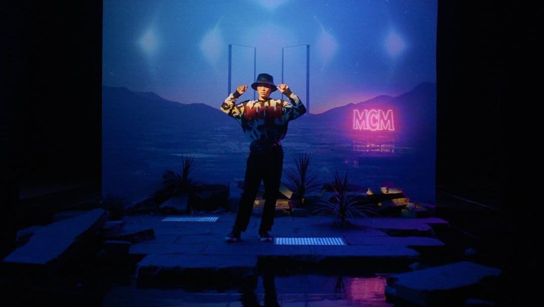 a man standing on a stage holding a baseball bat