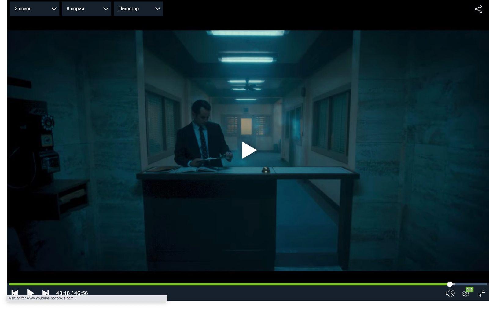 a man standing at a counter in a dark room
