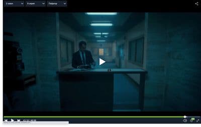 a man standing at a counter in a dark room