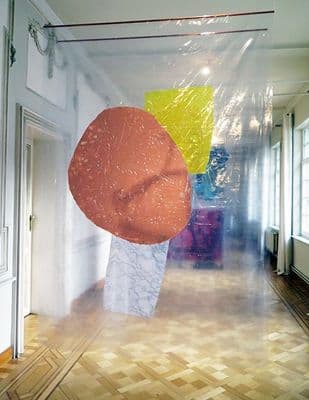 a room with a painting on the wall and a wooden floor