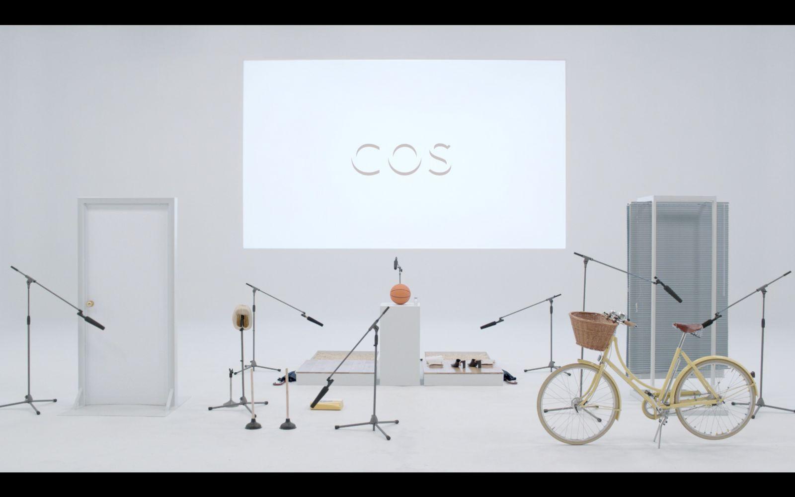 a white room with a bicycle and a projector screen