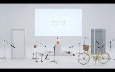 a white room with a bicycle and a projector screen