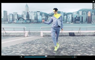 a man in a suit running on a sidewalk