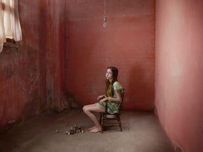 a woman sitting on a chair in a room