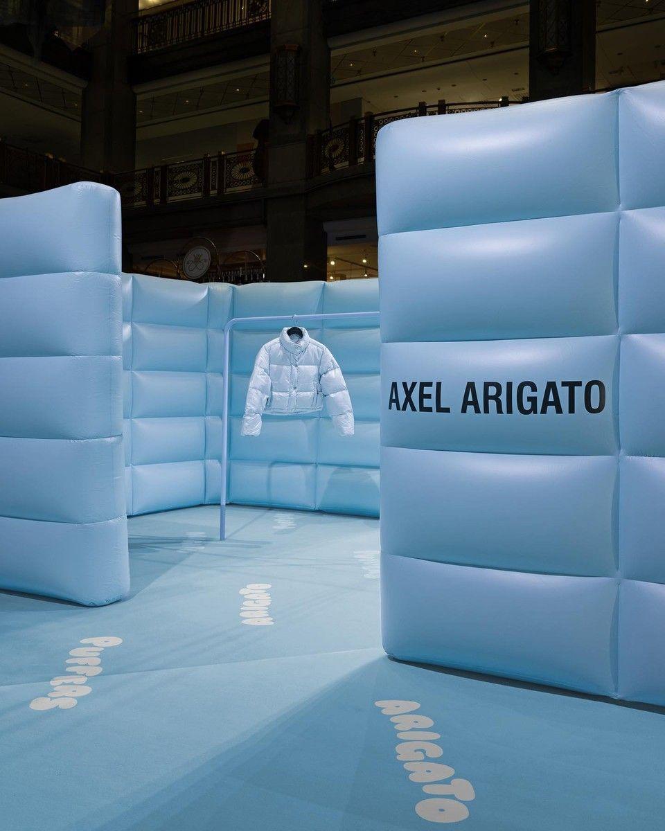 a white jacket is on display in front of a blue background