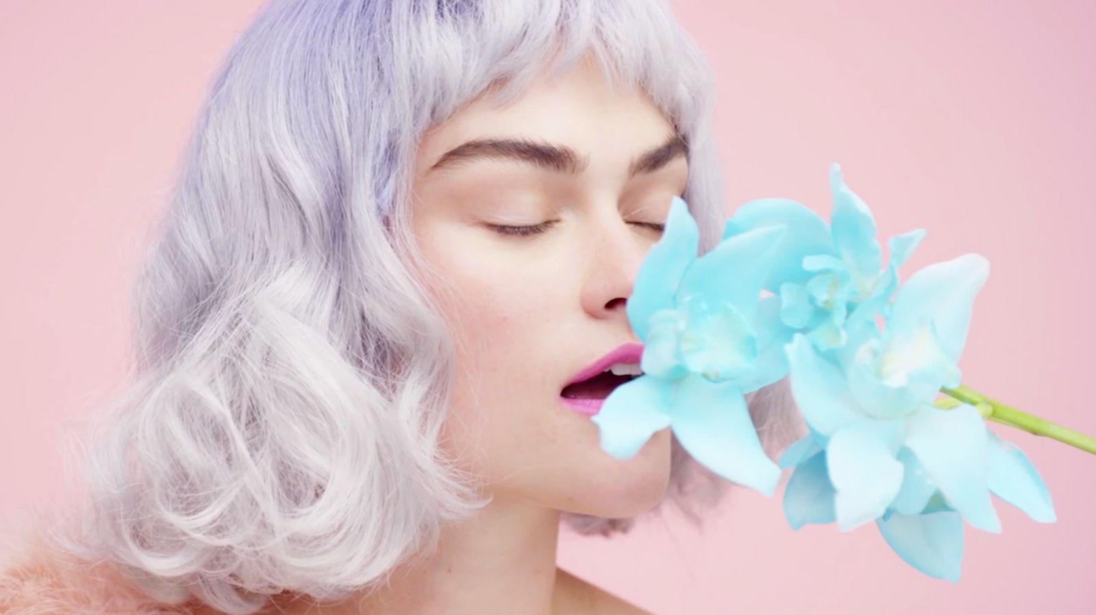 a woman with a flower in her mouth