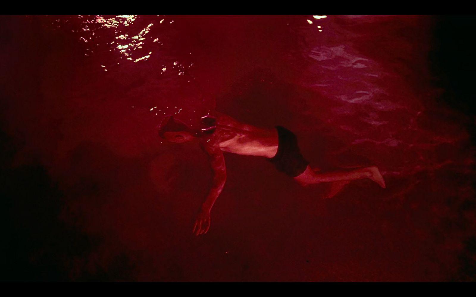 a man swimming in a pool of water