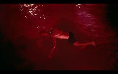 a man swimming in a pool of water