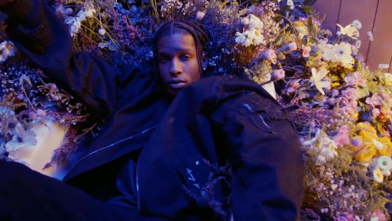 a man laying on the ground surrounded by flowers