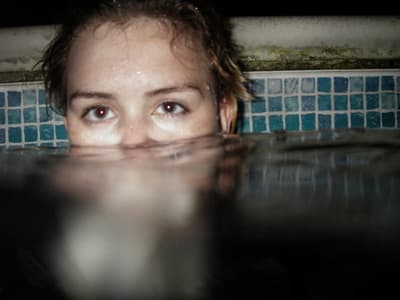 a woman is submerged in a pool of water