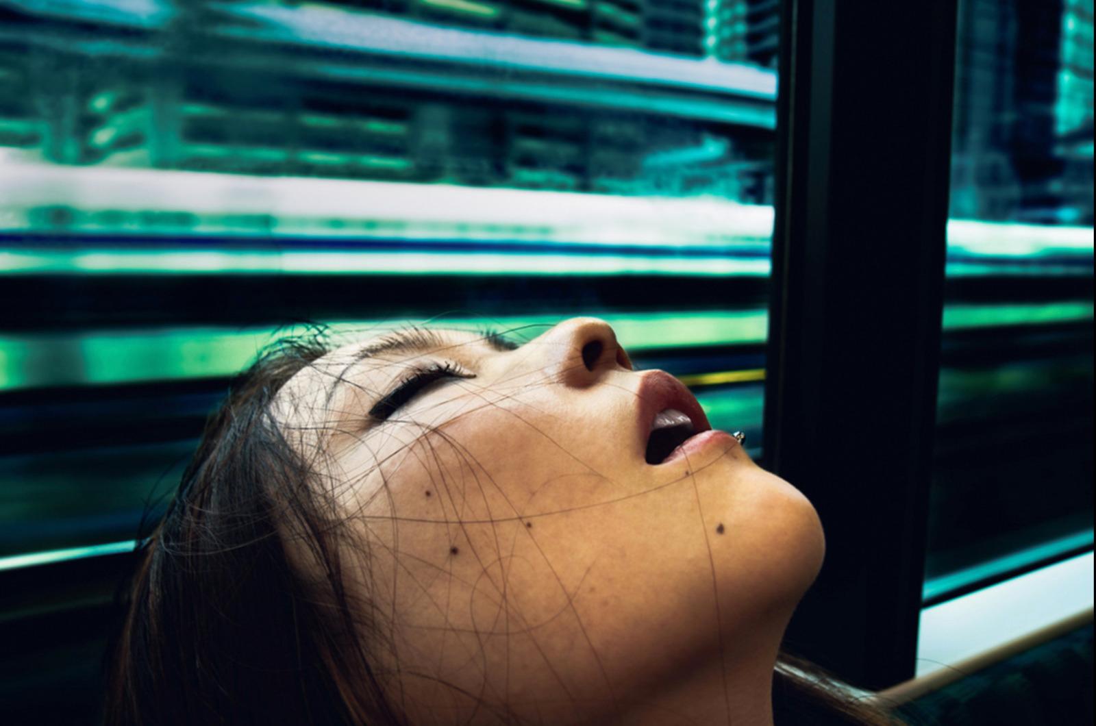 a woman looking up at a train passing by