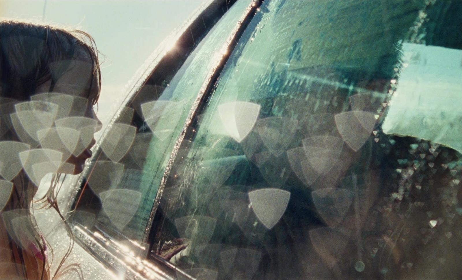 a woman looking out the window of a car