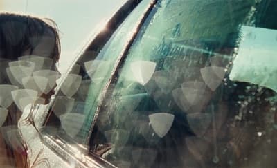 a woman looking out the window of a car