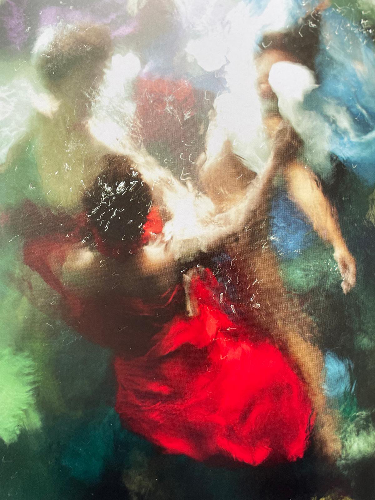 a woman in a red dress holding an umbrella