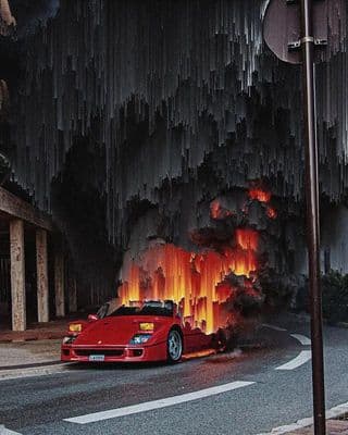 a red sports car driving down a street next to a fire