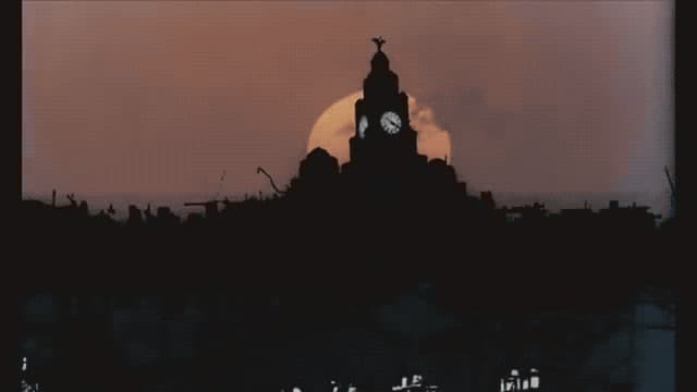 a clock tower with a full moon in the background