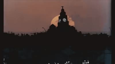 a clock tower with a full moon in the background