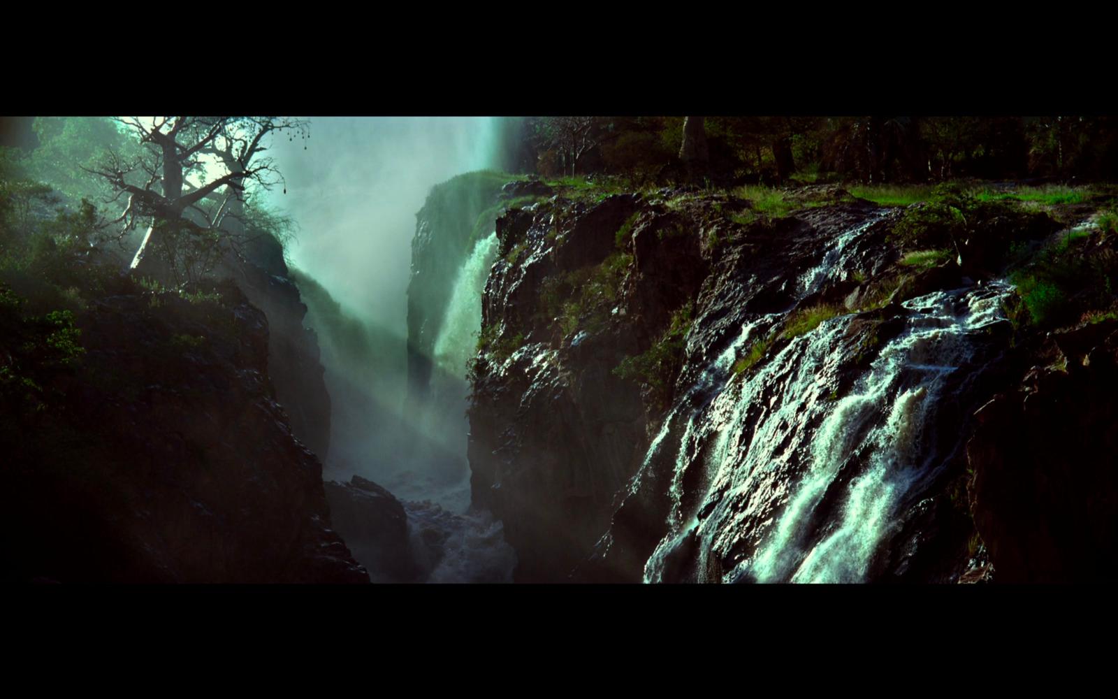 a waterfall in the middle of a forest