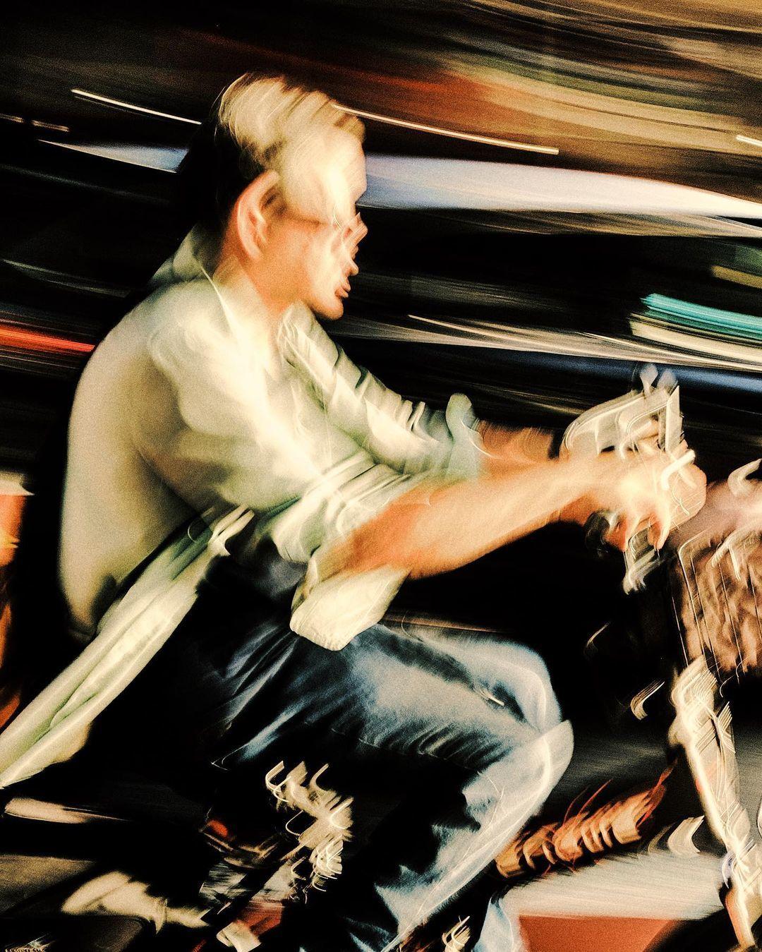 a man riding a motorcycle down a street