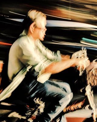 a man riding a motorcycle down a street