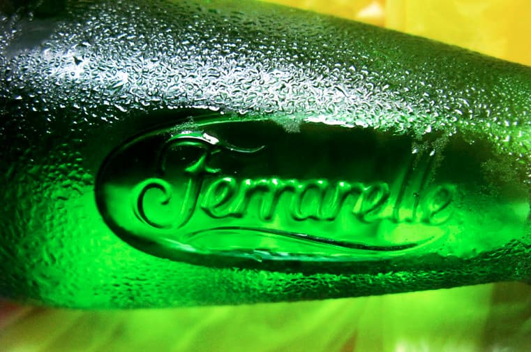 a close up of a green bottle of beer