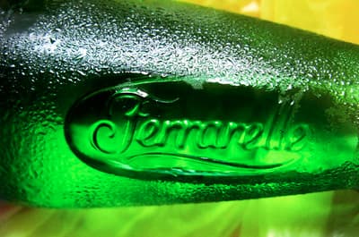 a close up of a green bottle of beer