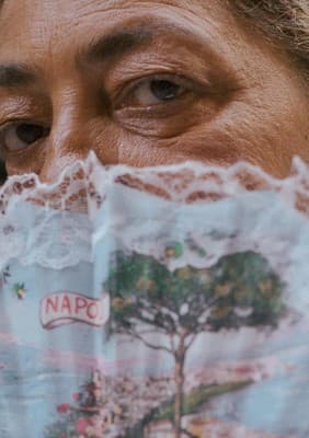 a close up of a person covering their face