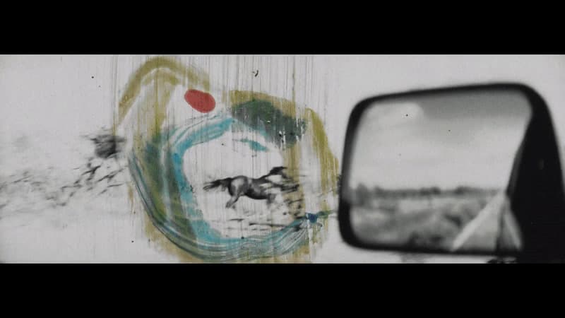 a side view mirror sitting on the side of a wall