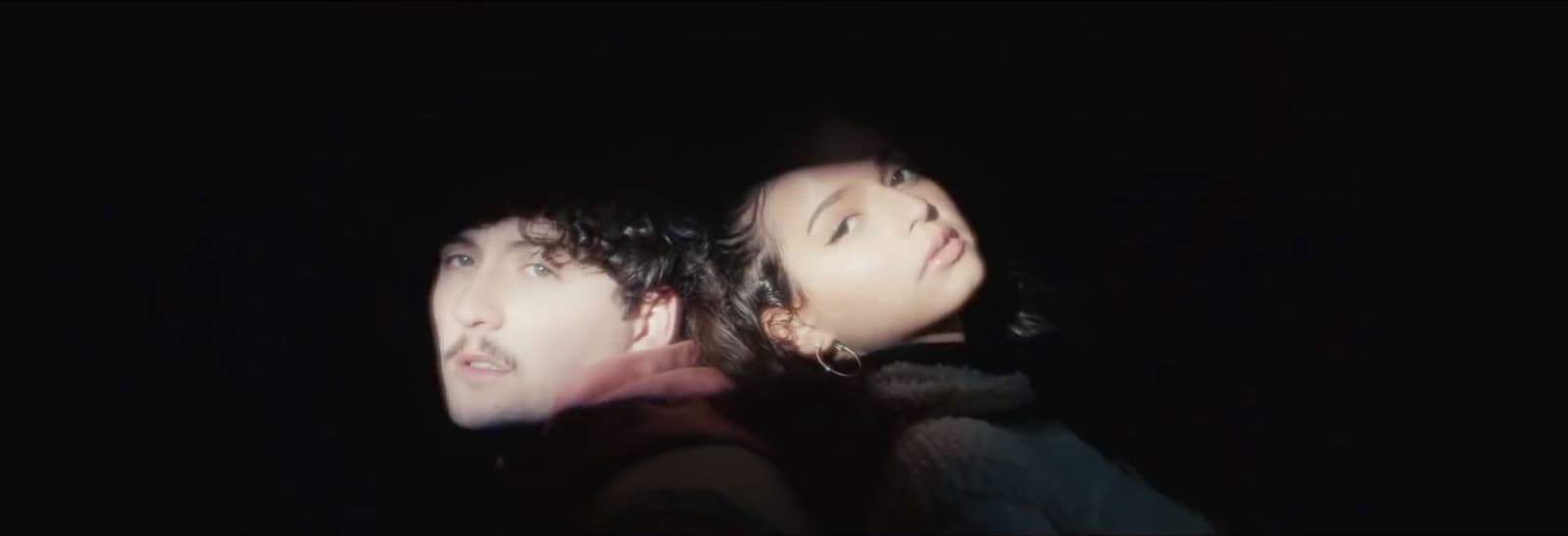 a man and a woman standing in the dark